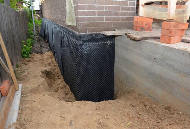 Happy homeowners after waterproofing job in Gobles